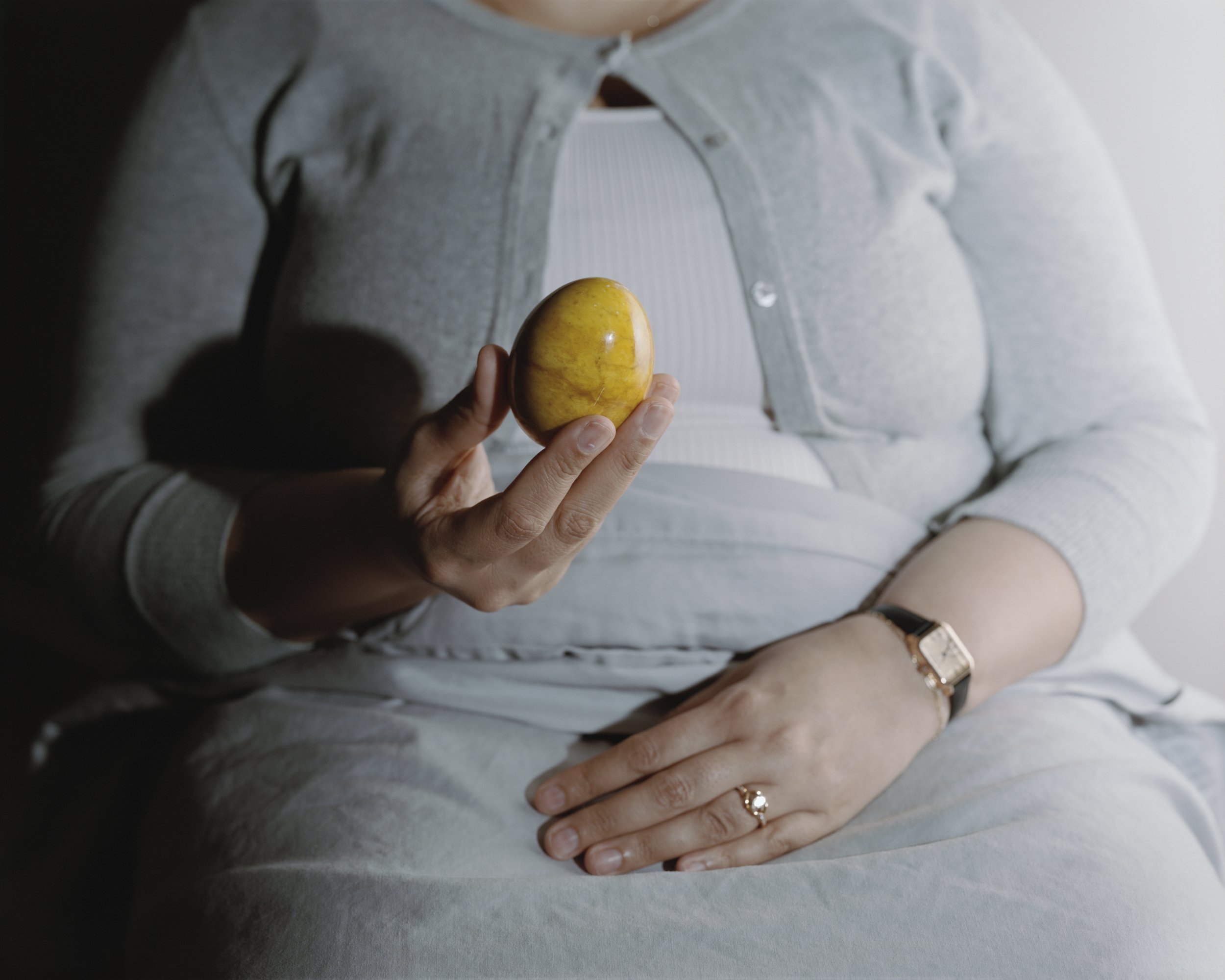 The Family Body: Daughter holding alabaster egg