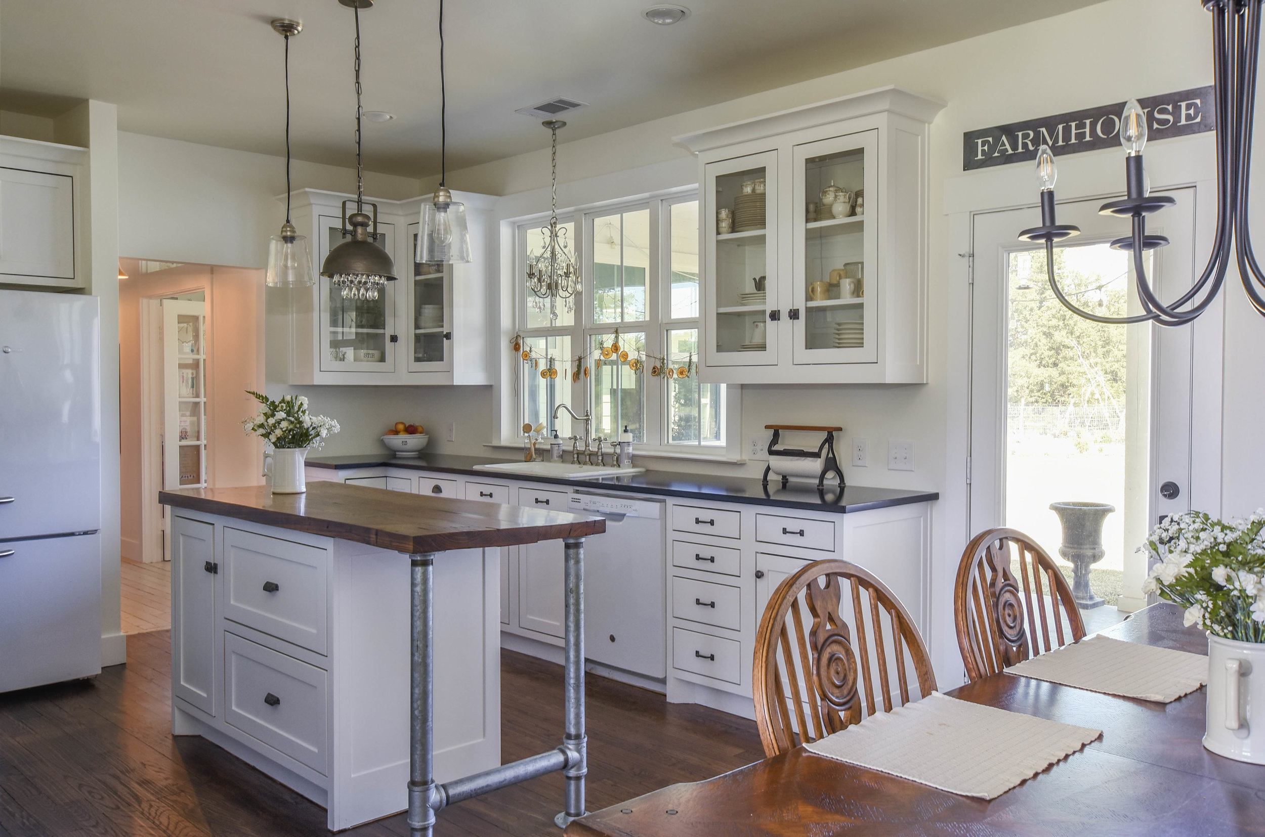 Shellie Bjork Photo of bright, white farmhouse kitchen and breakfast table
