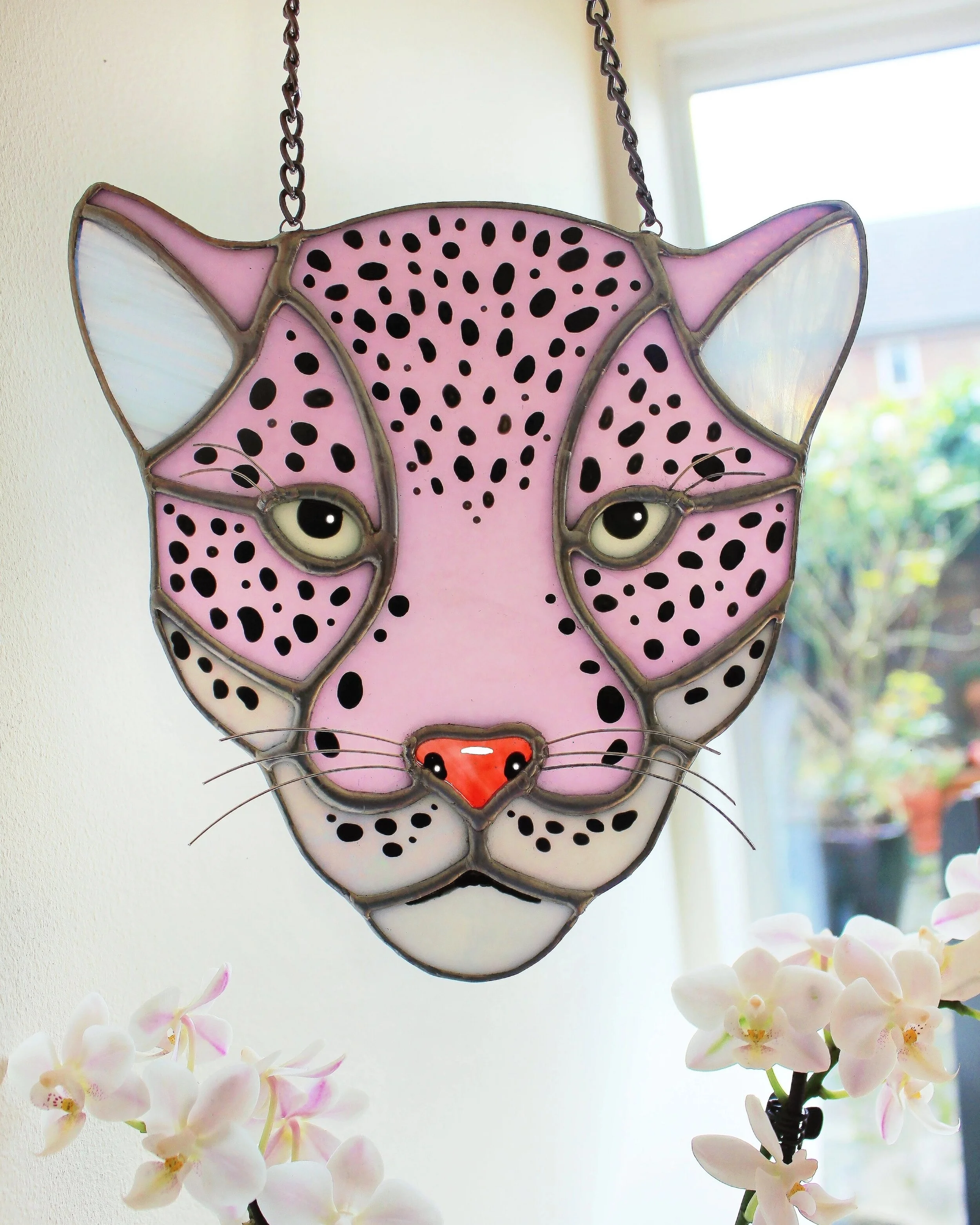 Vibrant stained glass leopard hanging handcrafted in London, featuring an intricate leopard design, ready to hang with a chain.