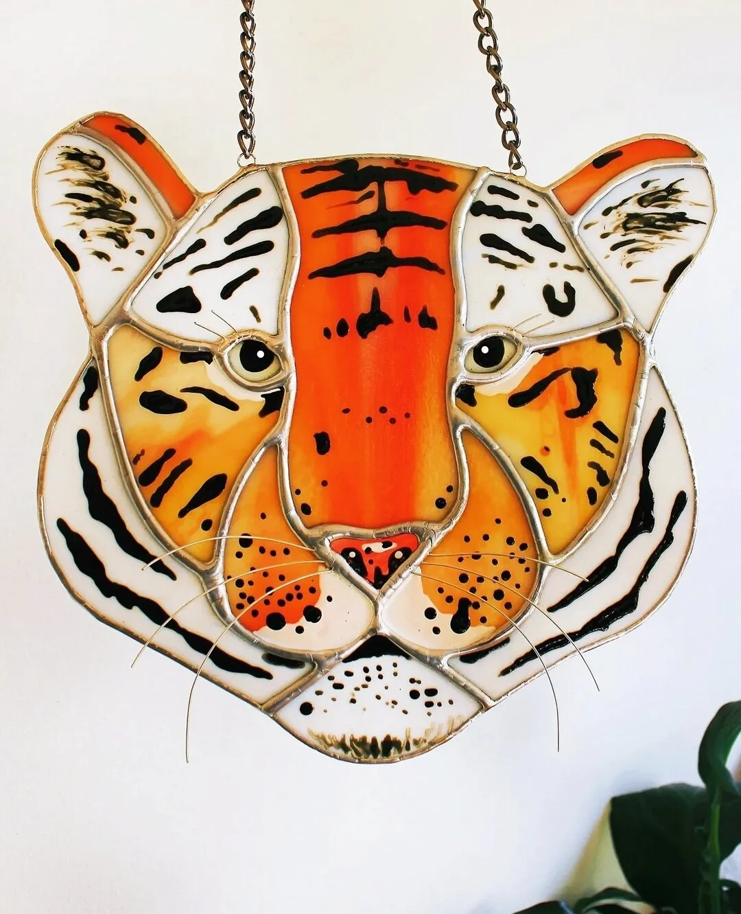 Stained glass tiger suncatcher handcrafted in London featuring a vibrant tiger design, perfect for hanging in windows.