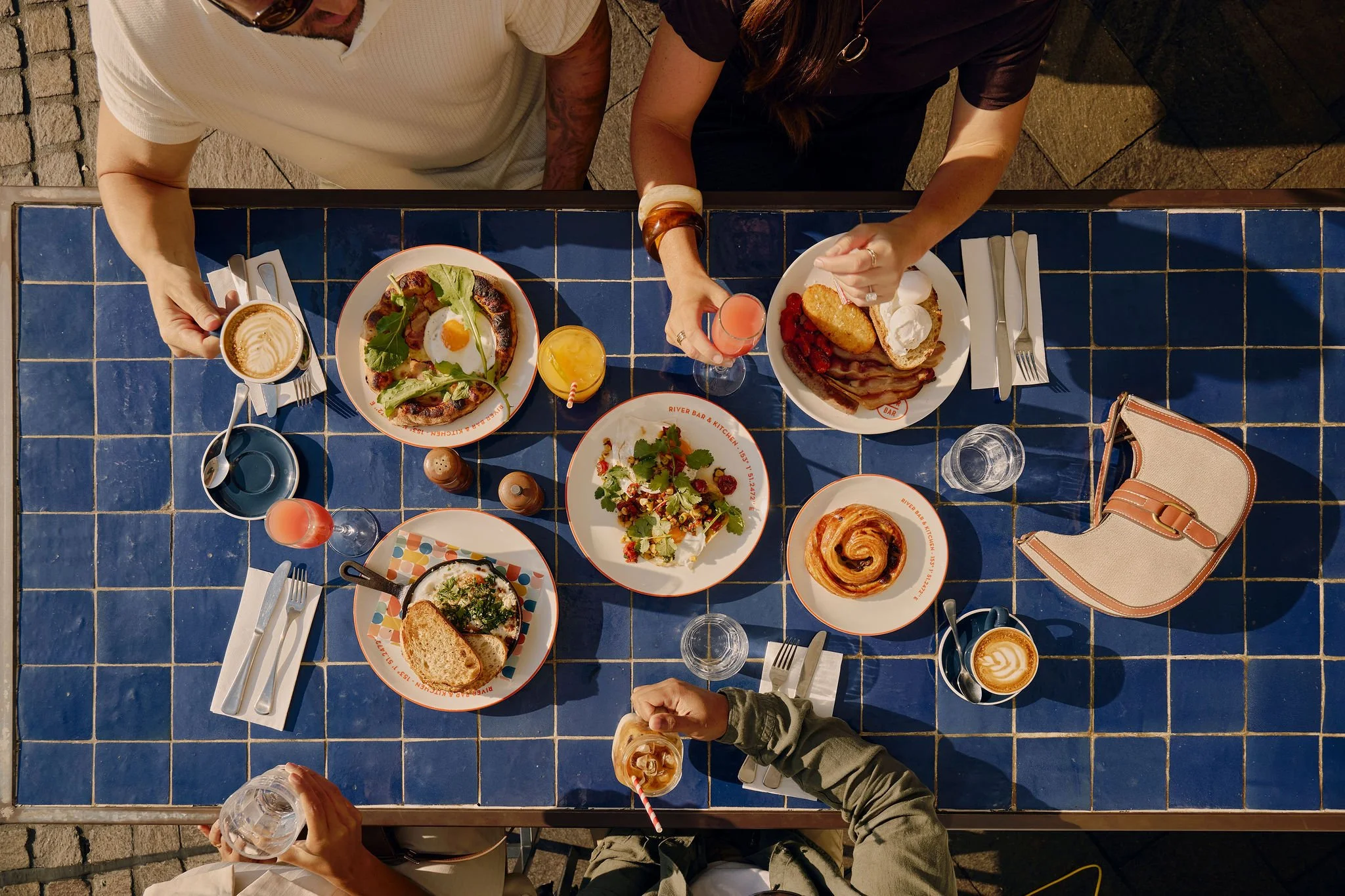 Brunch spread with coffee, pastries and breakfast dishes at a Brisbane cafe