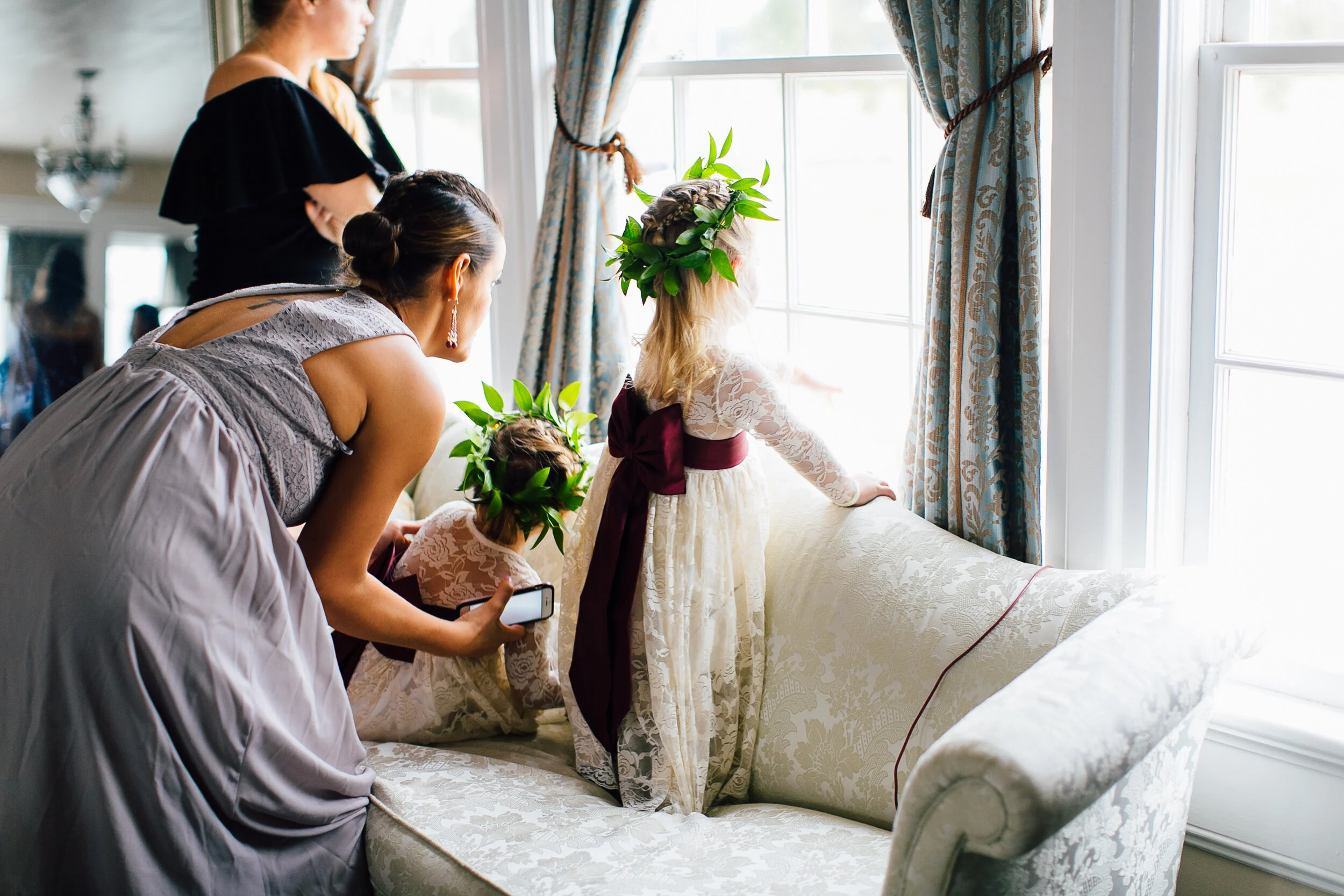 Sweet flower girl peeking out the window