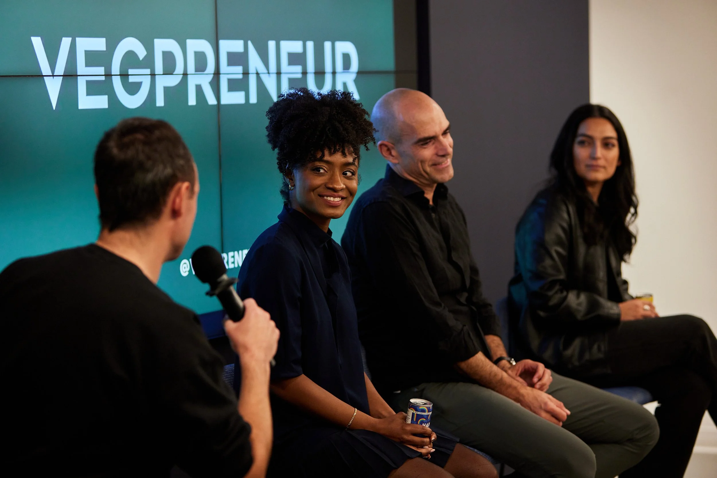 four-panelists-on-stage-vegpreneur-screen.jpeg