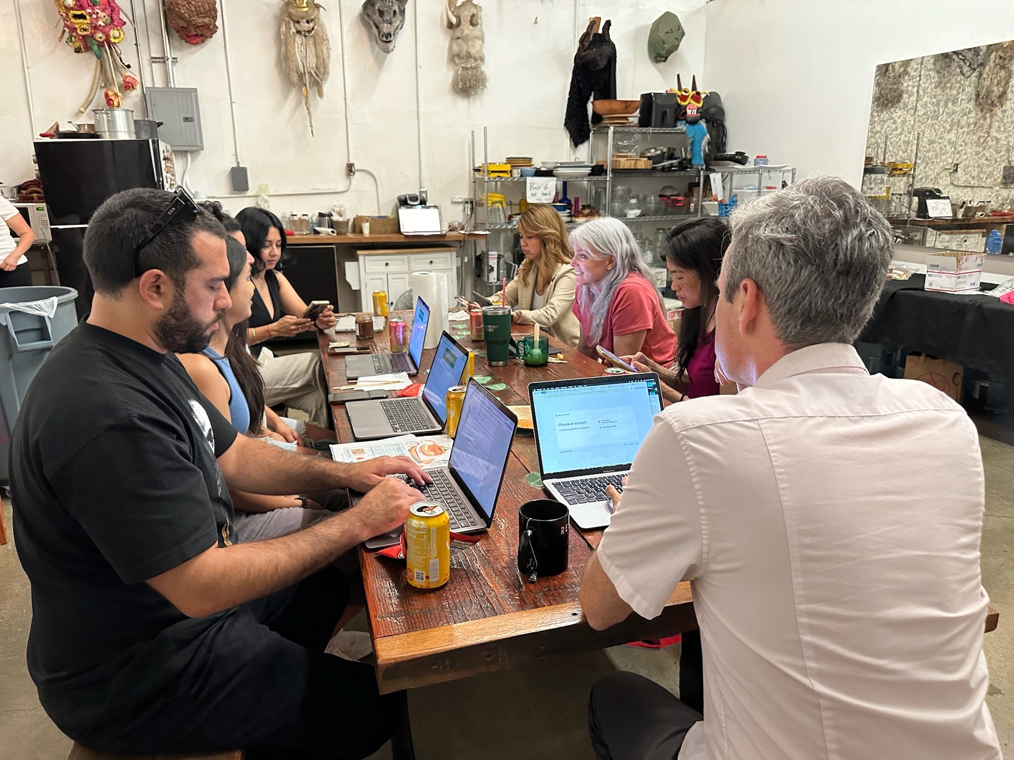 group-working-on-laptops-at-long-table.JPG