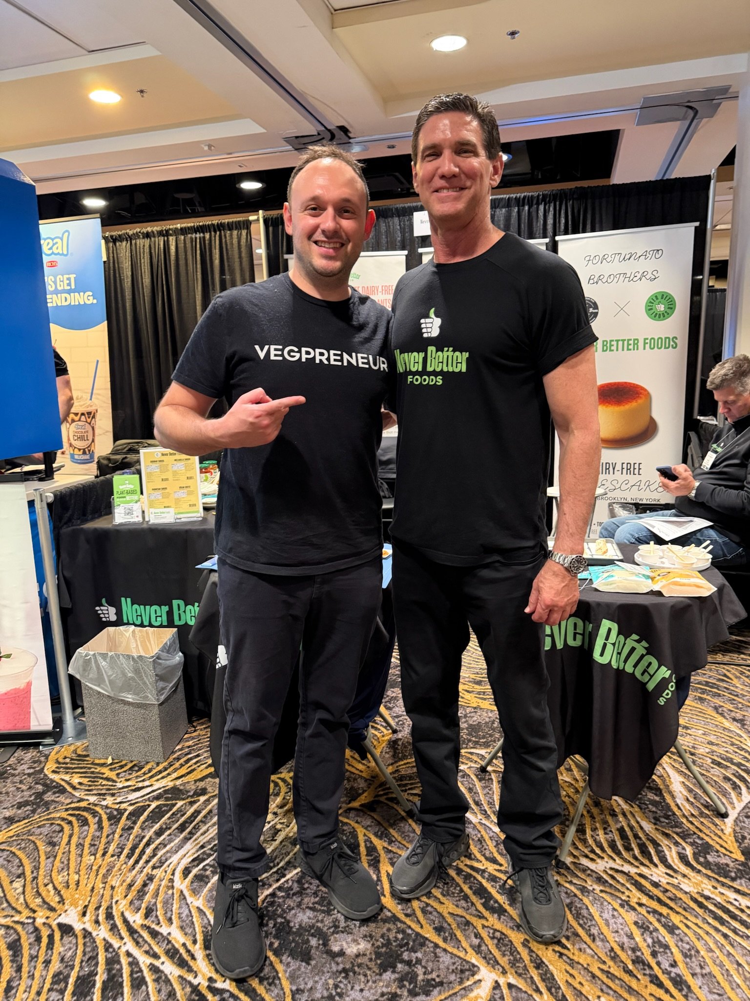 two-men-posing-at-never-better-foods-booth.JPG