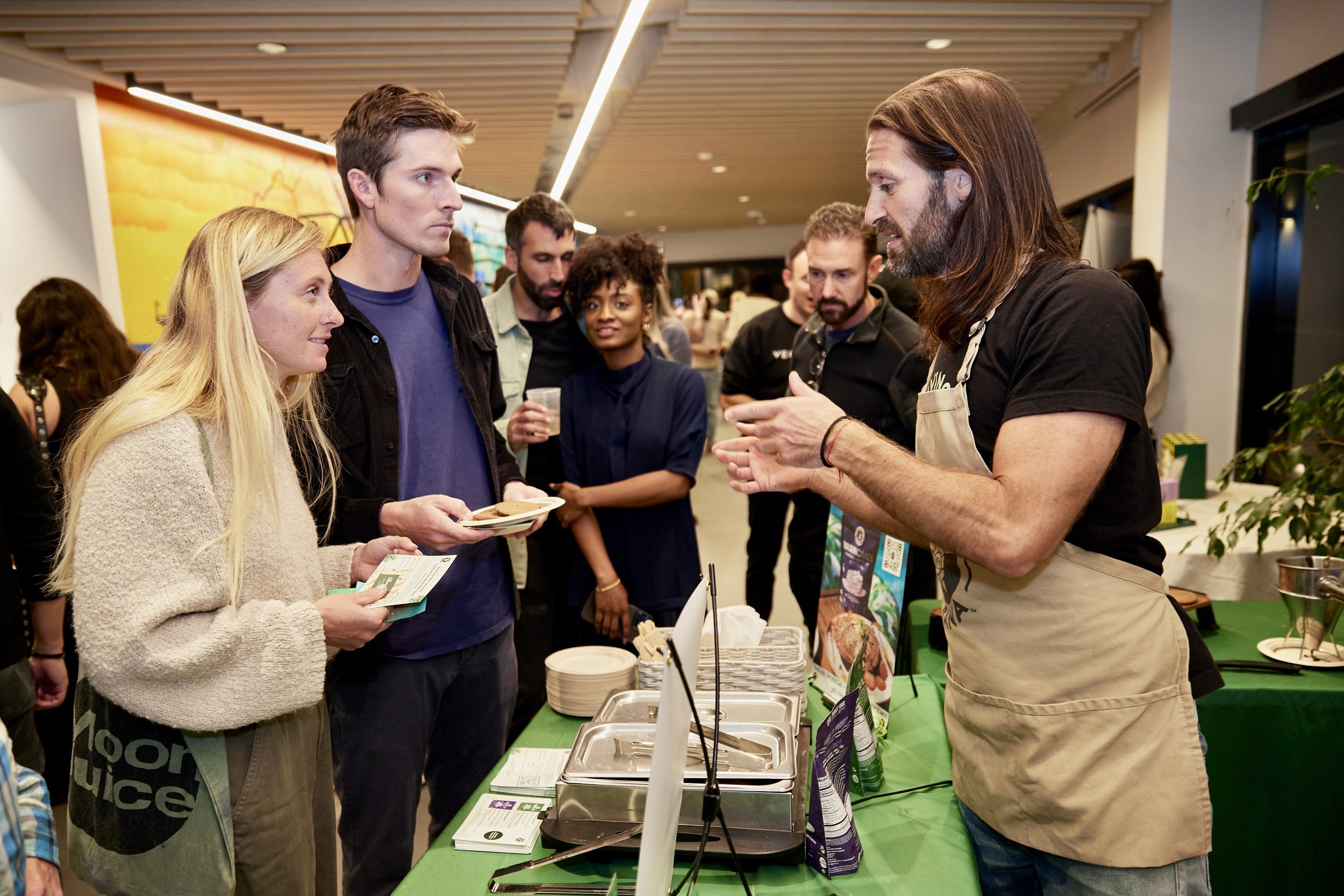 vendor-talking-to-attendees-at-food-booth.jpeg