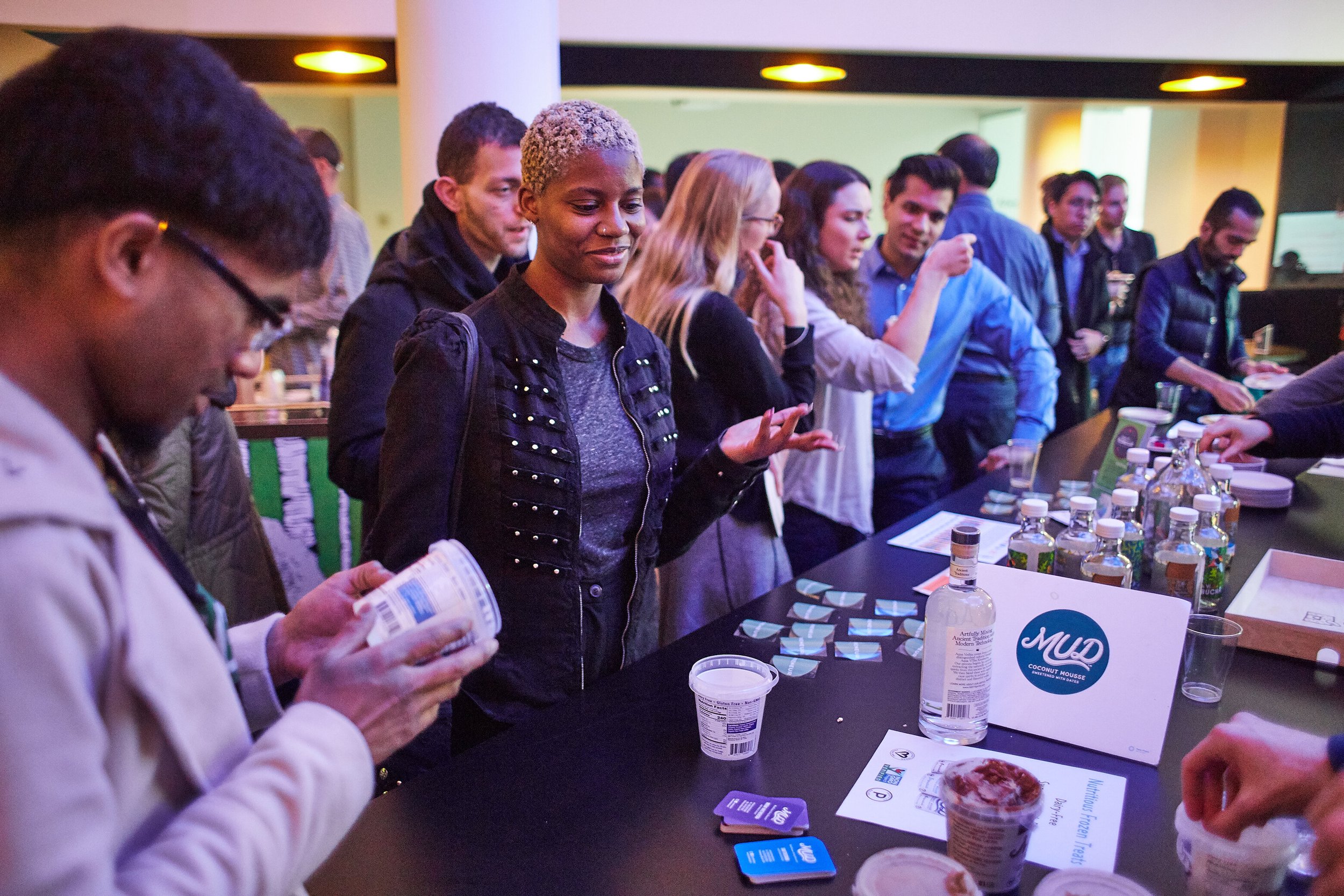 attendees-sampling-products-at-event-booth.jpeg
