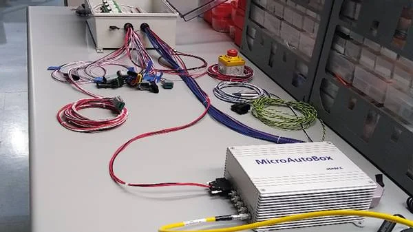 Pilot Systems built and installed a relay box (upper left) for the MIT CSAIL team. The relay box switches actual sensor signals (e.g., for acceleration, braking, and steering) to the MicroAutoBox, where they are converted into inputs and sent to the vehicle’s electronic control units for autonomous control. The relay box also serves as a signal conditioner for sensors, such as axle encoders, to accurately calculate distance and speed.