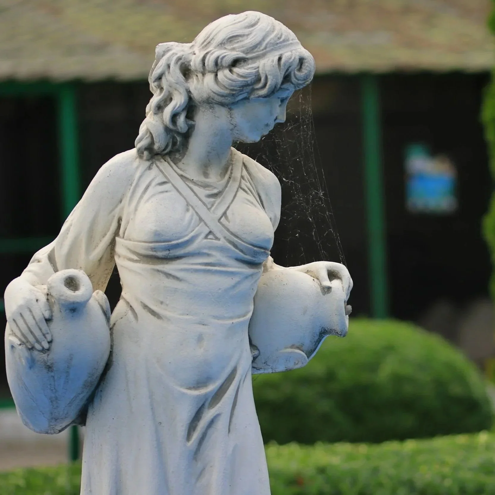 Stone statue of a water bearer representing the symbolism of the Aquarius Full Moon, authenticity, and personal growth.