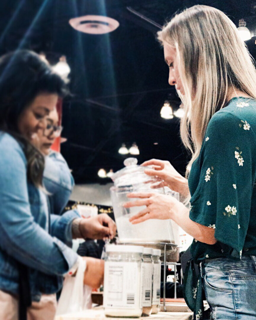 exhibit-show-woman-receiving-protein-powder-samples.jpg