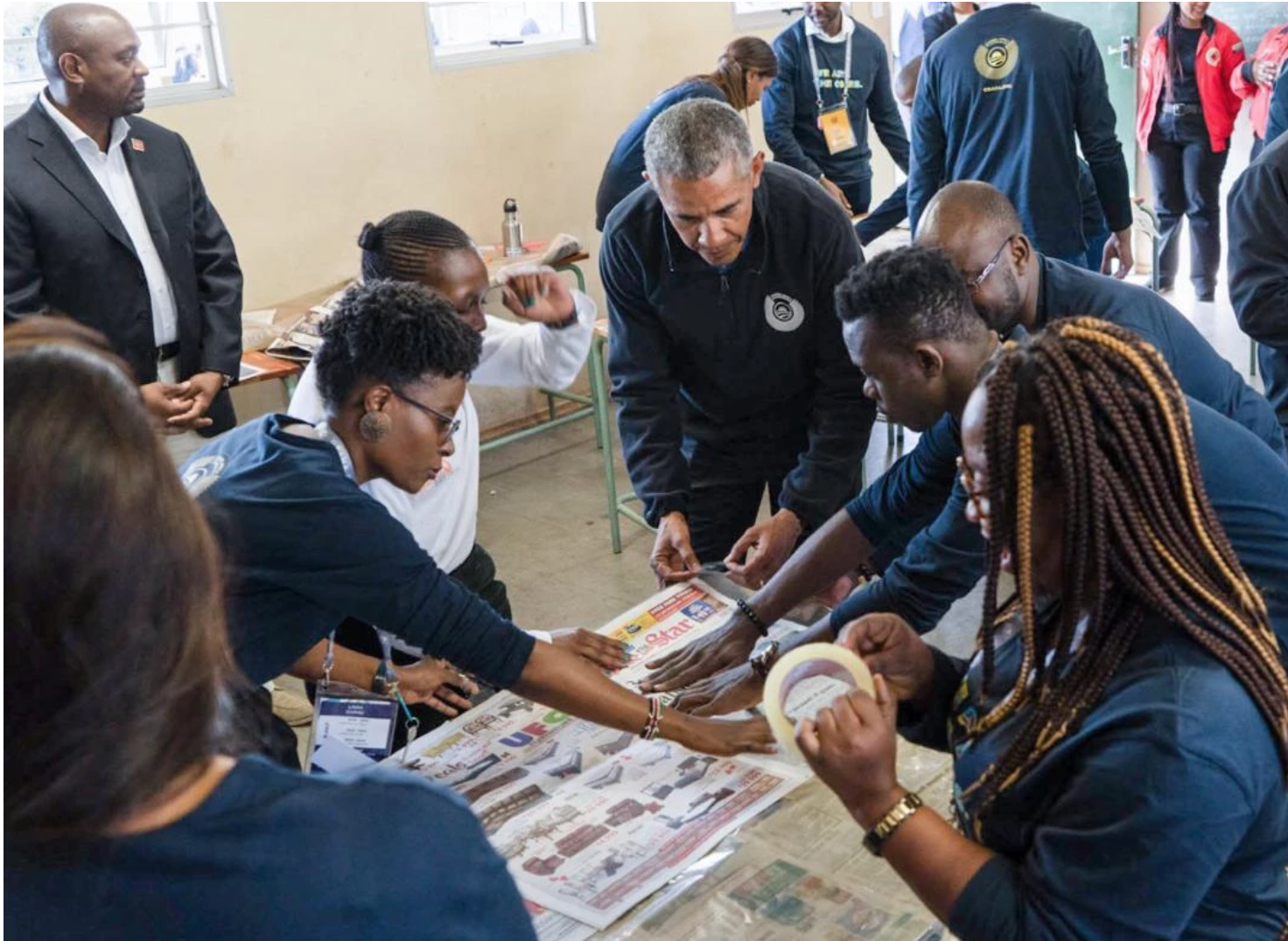 Francisca (bottom right) makes sleeping mats for the homeless with former President Barack Obama during a five-day leadership program in Johannesburg, South Africa.