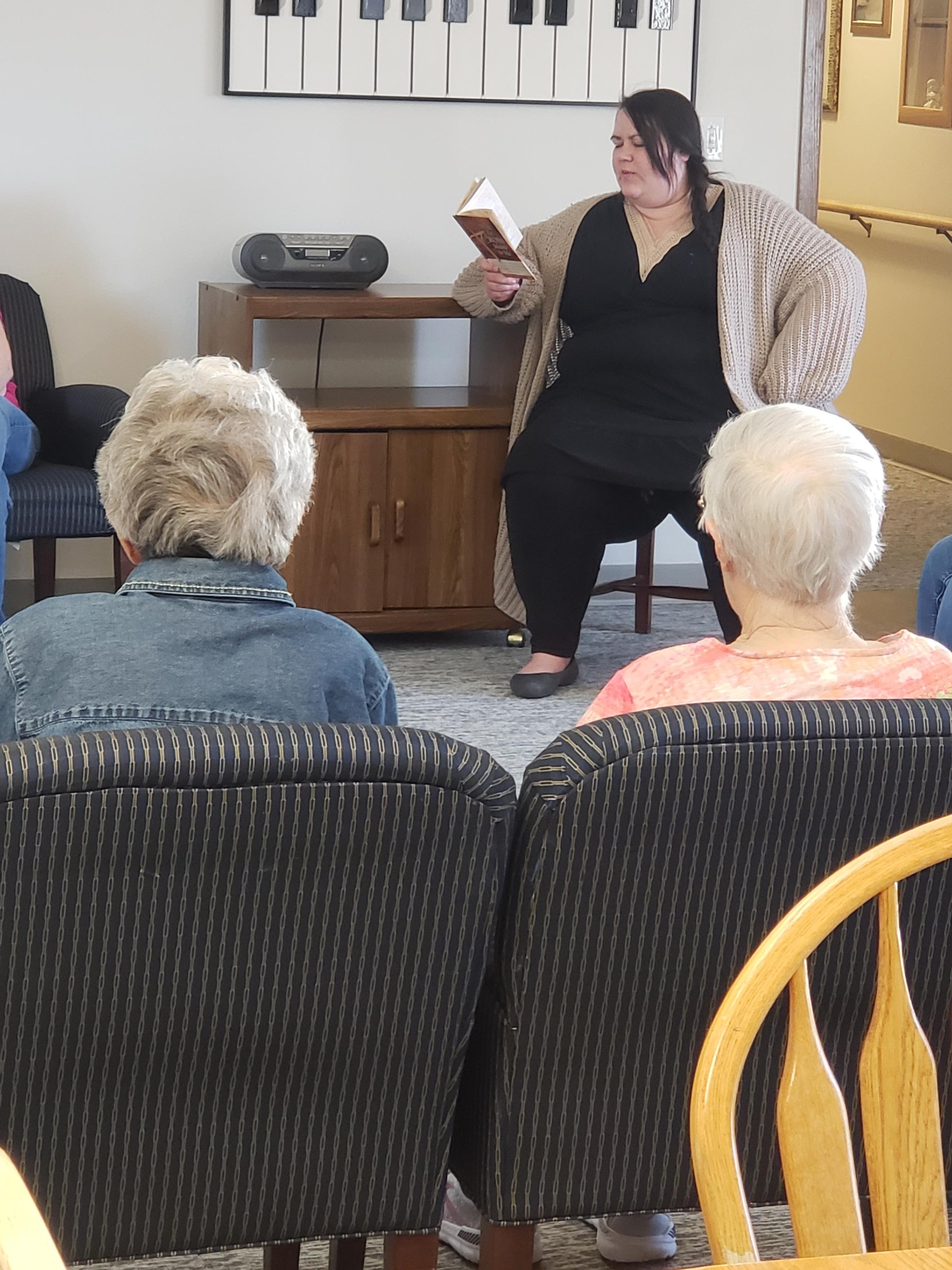 Amanda Himmerich reading to the residents