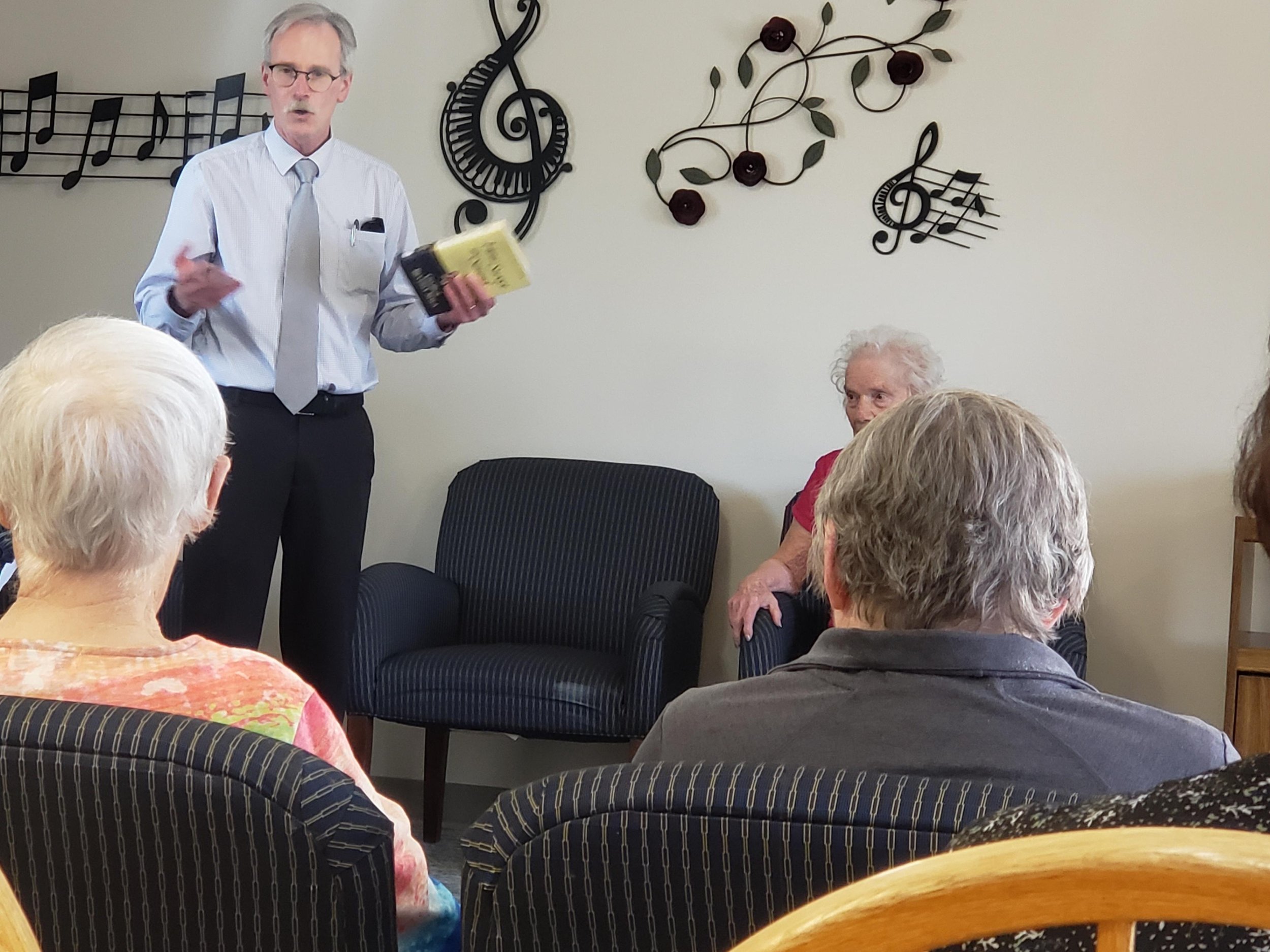 Russ Garrett leading residents in singing hymns