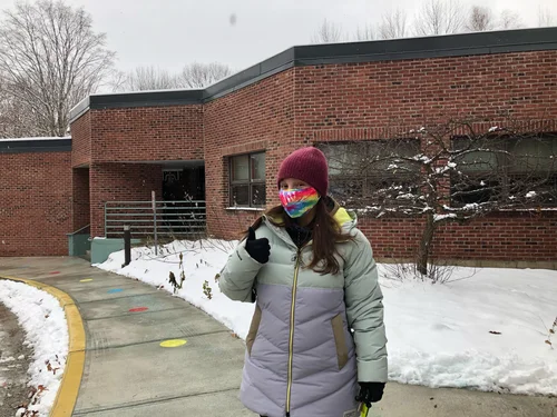 Web developer Sarah Harissis posing in front of the Smilie Memorial School in Bolton before casting her vote. (Scott Barnes/Community News Service)