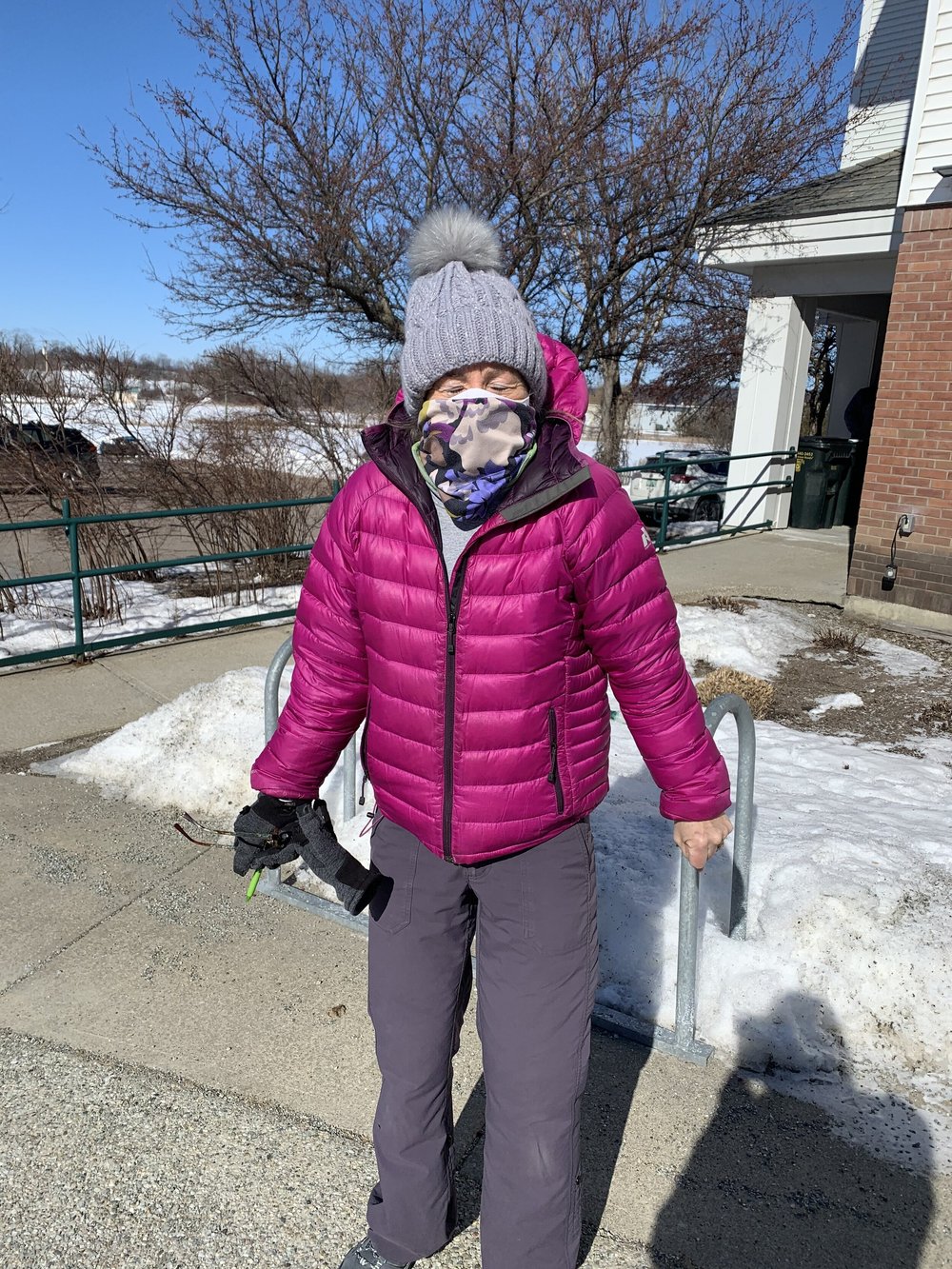 Kris Anderson bundles up “to show just how cold it is” on Town Meeting Day 2021. (Maddy Holden/Community News Service)