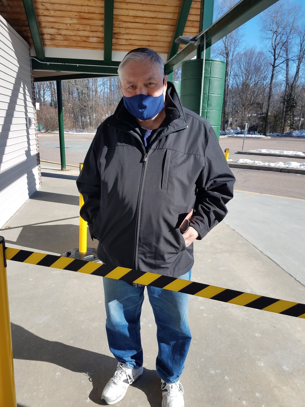 Donald Metcalf stops for a picture on his way inside the Chamberlin School. (Claire MacQueen/Community News Service)