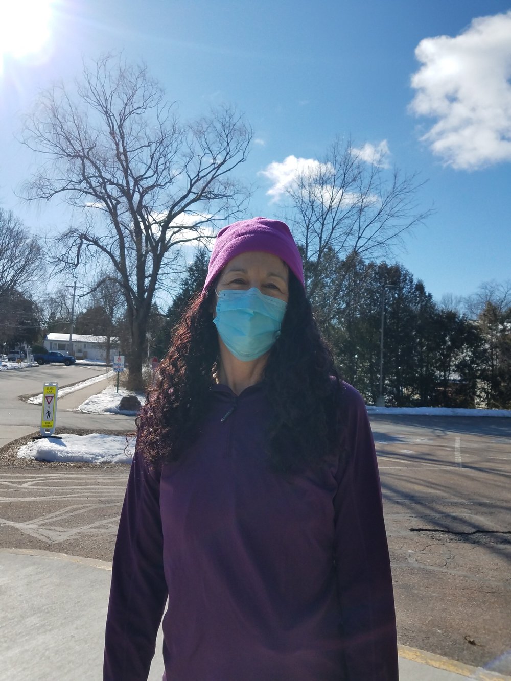 Catherine Young stops for a picture after casting her ballot inside the Chamberlin School. (Claire MacQueen/Community News Service)