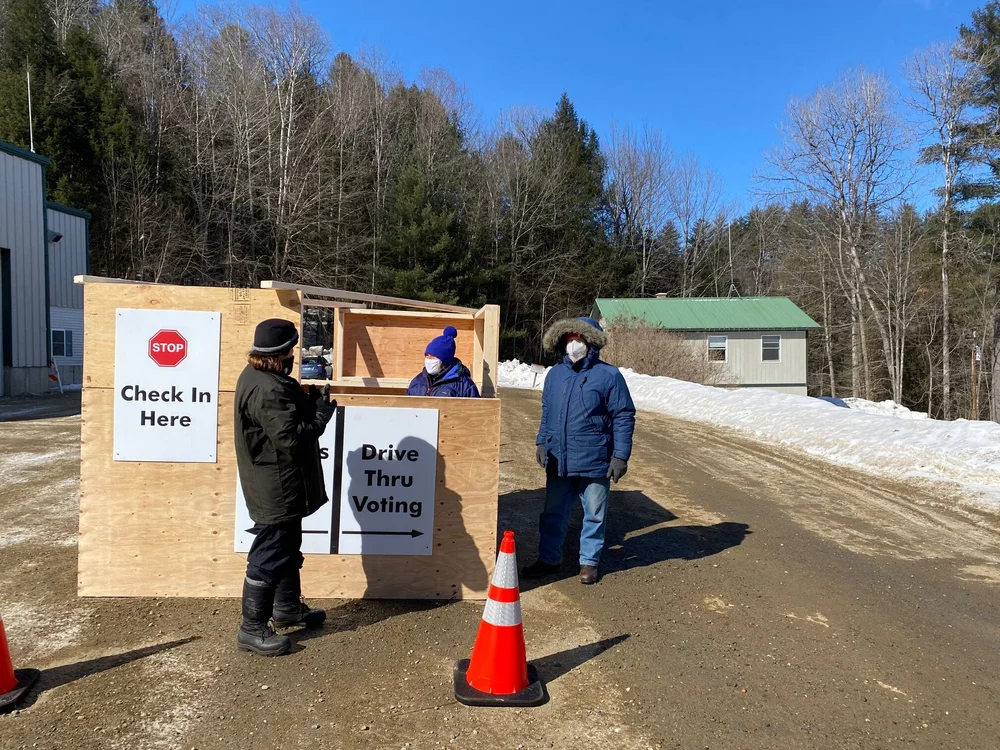 Town Clerk Maureen Harvey (left), Jill Smith (center), and Dan Cordozo (right), welcome drive-in voters in Duxbury. (Kris Nine/Community News Service)