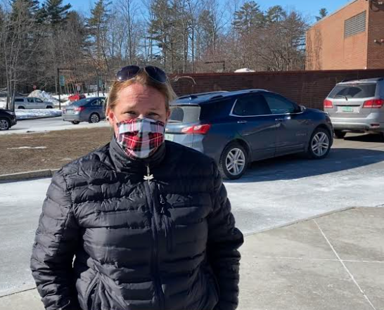 Megan Nolan, a Colchester parent, prepares to vote outside Colchester High School gymnasium on Tuesday, Mar. 2, 2021. (Brian Behrens/Community News Service)