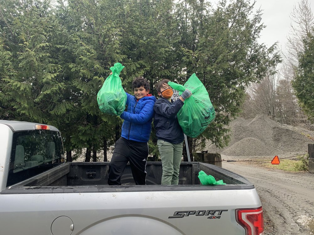 Lakeview Union students Christoper Tongelai (left) and Jin Ramsay (right) show off all of the garbage they have picked up for Green Up Day. (Anna Kolosky/Community News Service)