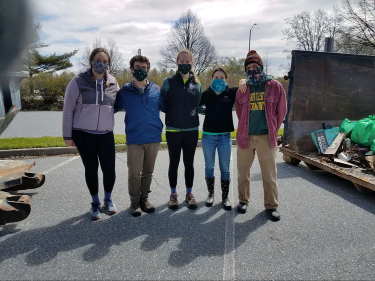 Team “Trash Talk” poses in front of the dumpster in the City Hall Parking Lot.  Left to Right: Hailey, Ben, Morgan, Sarah and Doug  (Claire MacQueen/ Community News Service)