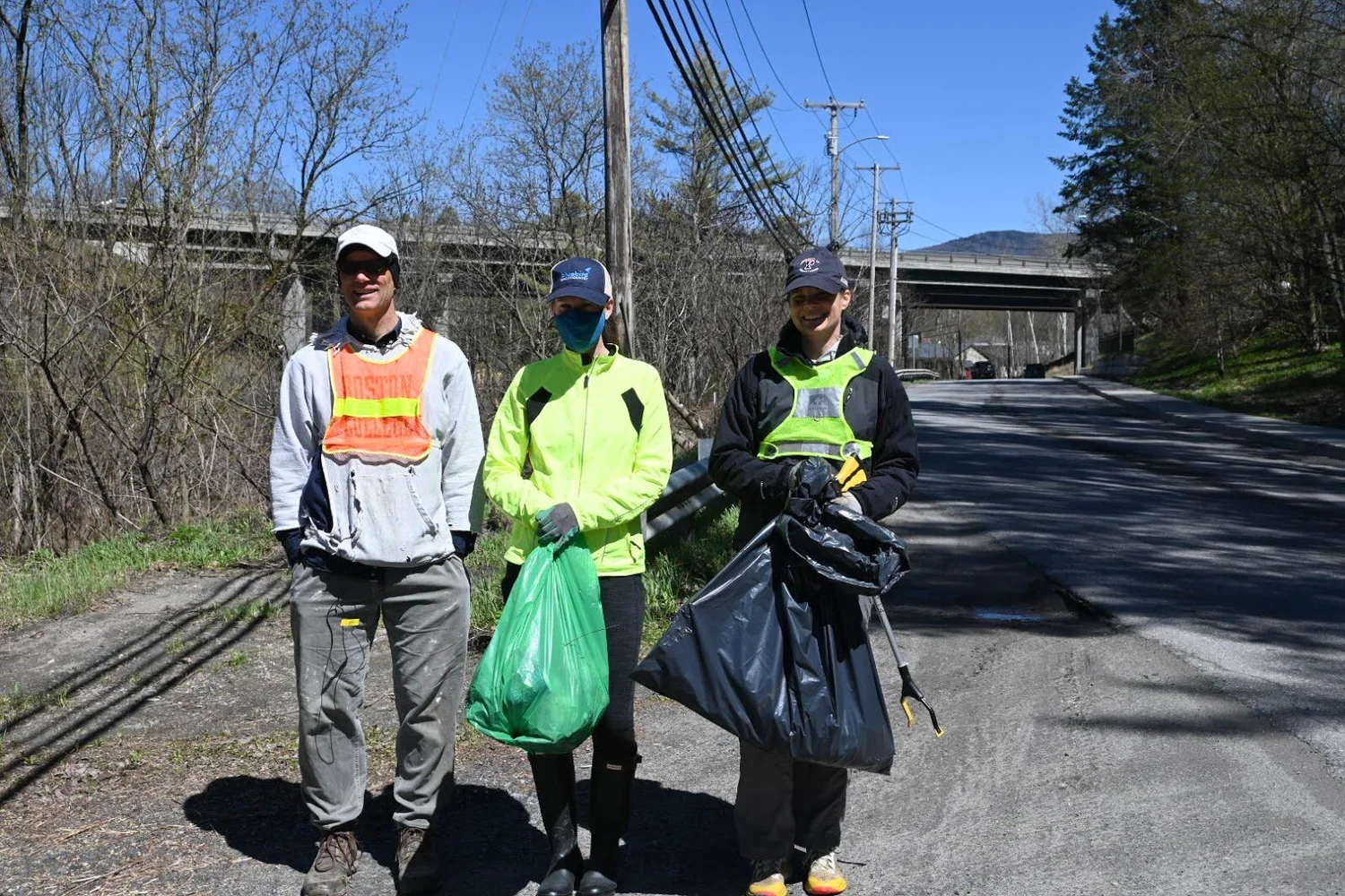 Left to right: Matthew Dugan, Laura, and Heidi Dugan are neighbors who were brought together for one of the first times by Green Up Day. Photo by Jenny Koppang.