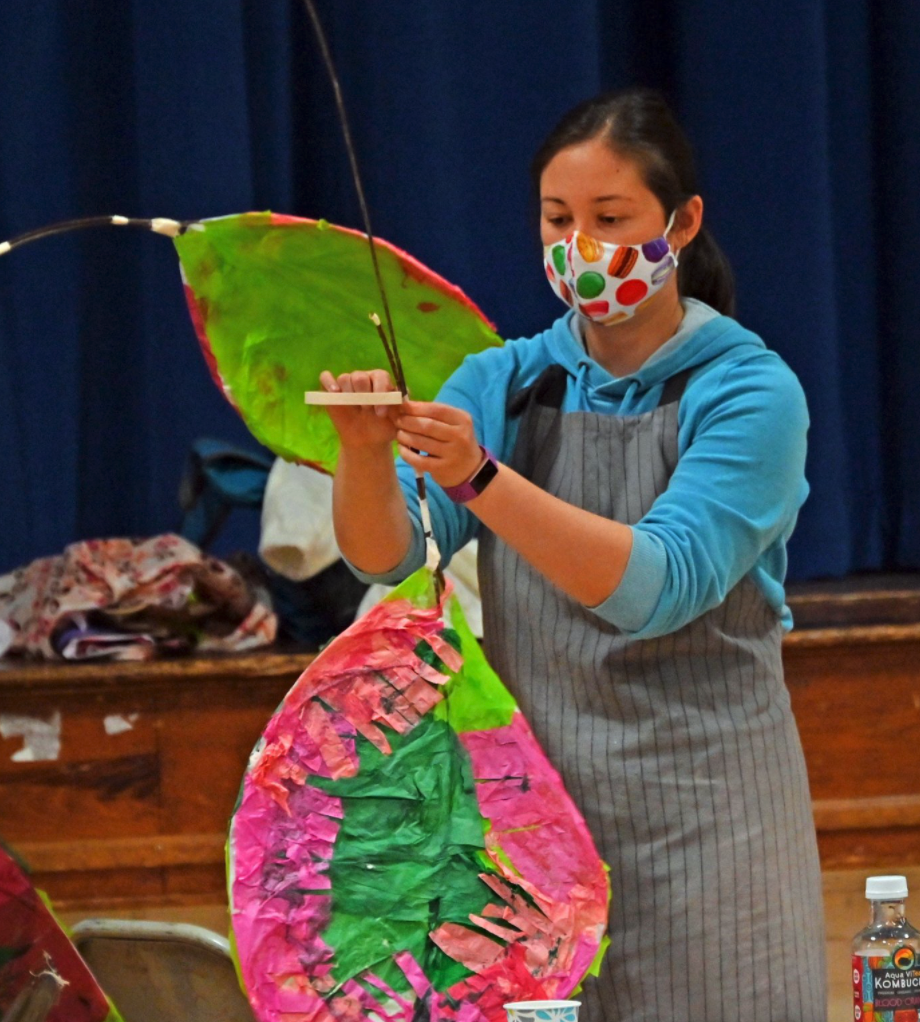  Community members create lanterns that will stand out among the smaller ones made by the primary school students. Chiyomi McKibbin’s rubber plant lantern is especially colorful. Photo by Gordon Miller  