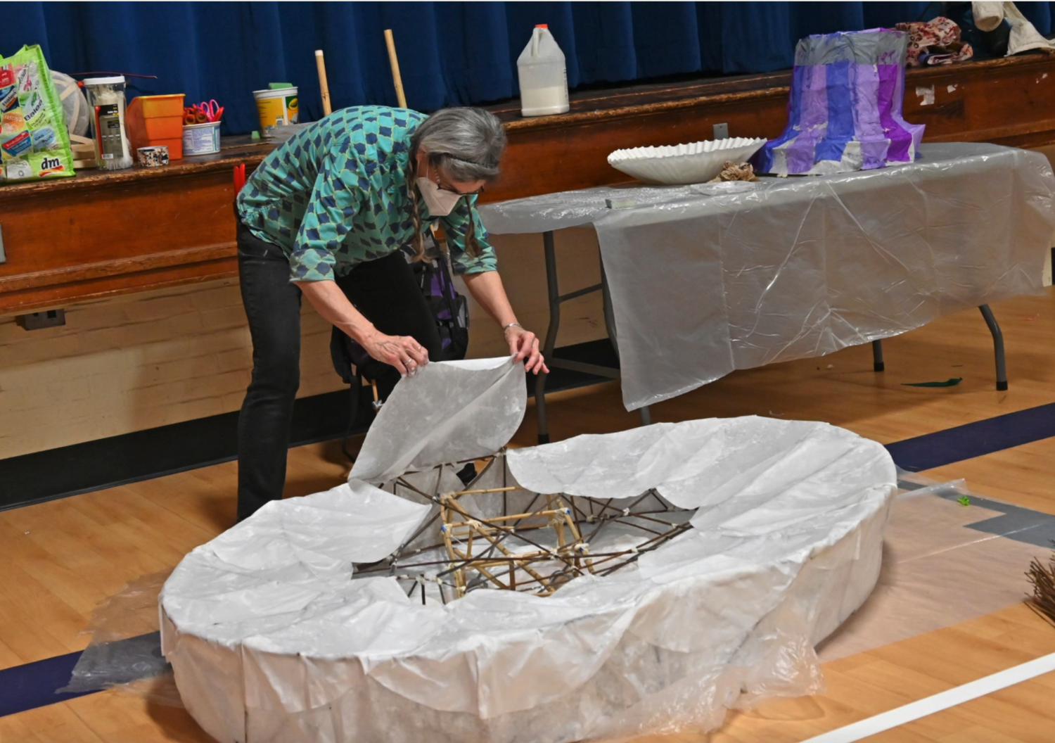  Mame McKee carefully works on a large artist palette lantern. Photo by Gordon Miller  