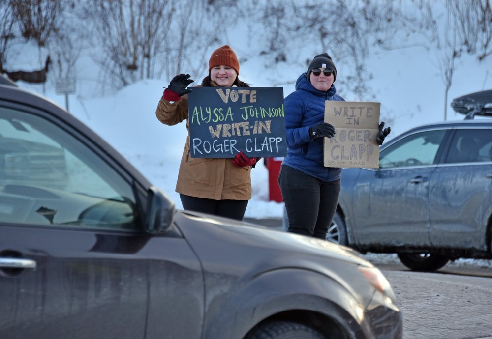   Tessa Yip, left, and Mallory Culbertson, right, show support for Johnson and Clapp at the roundabout on Monday. Photo by Gordon Miller  