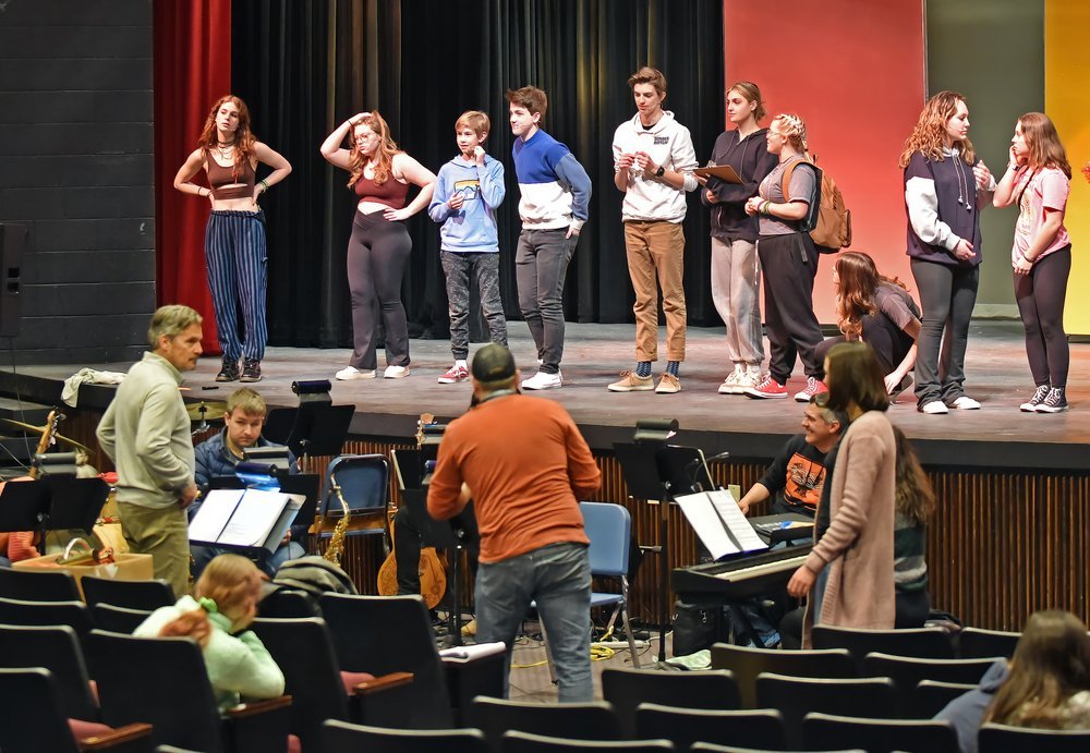   Mic check for cast members during a tech week rehearsal. Photo by Gordon Miller.   