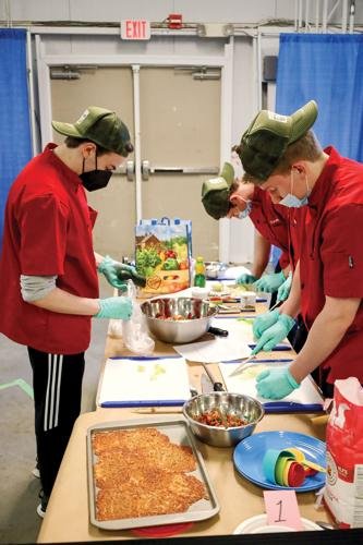   A Jr. Iron Chef Vermont team from Champlain Valley Union High School prepares a meal for this year’s competition.   