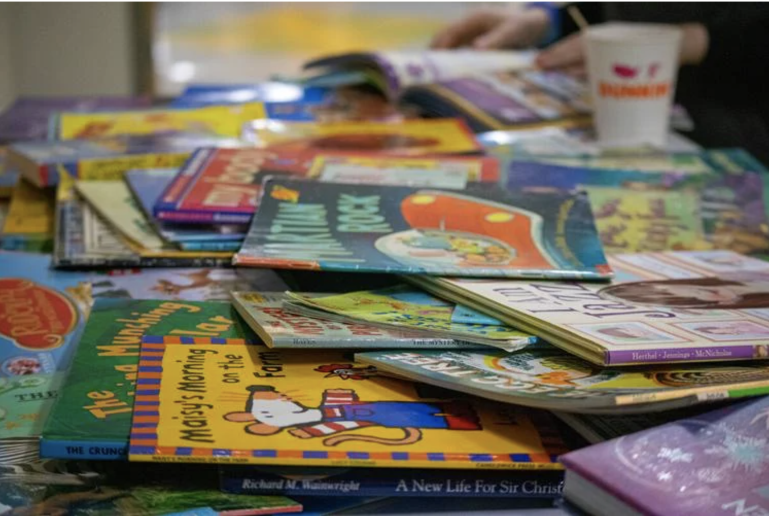  A pile of books covers a table at the Shelburne Community School on Feb. 9, as part of the school’s Read-a-thon.&nbsp;  Photo by Aylin Kursat 