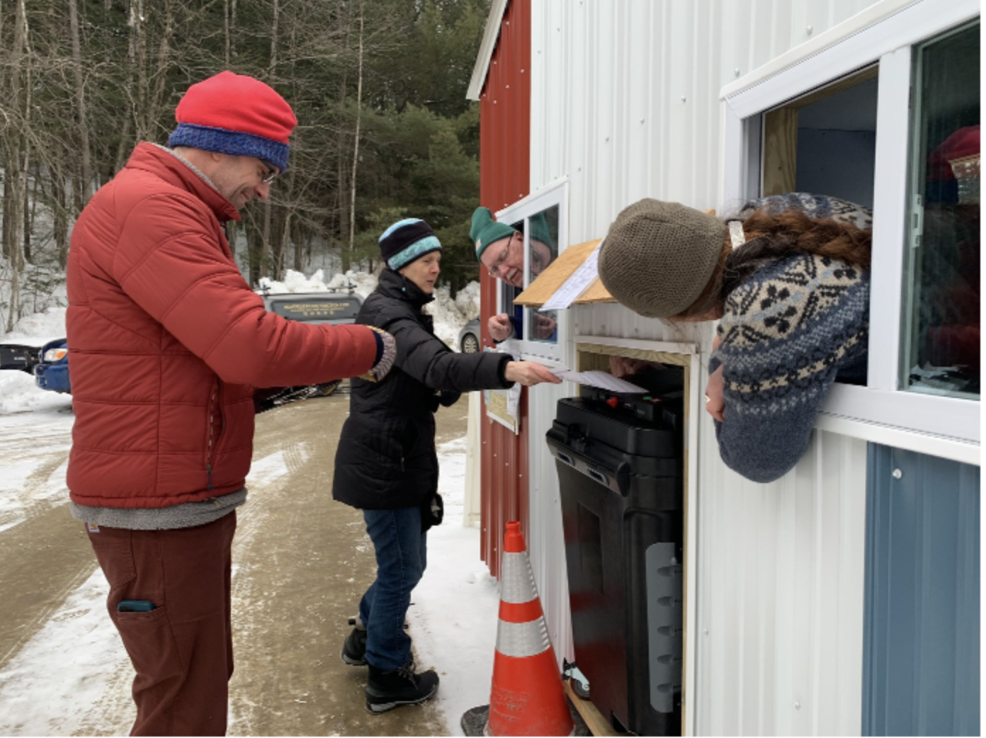  Trevor Cole (left) and Kelley Taft (center) cast their ballots and check out on foot while their car is at a shop nearby on Town Meeting Day. Photo by Lisa Scagliotti 