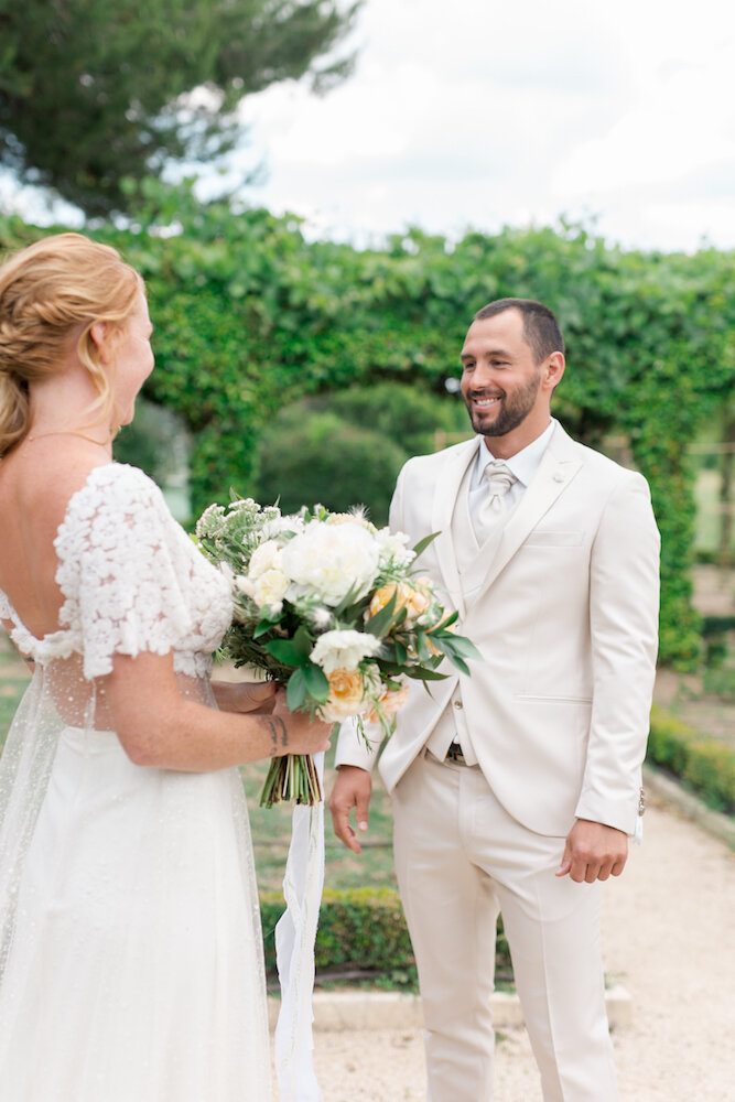 Le first look dans un mas provençal lors d'un sublime mariage, le mari qui regarde sa femme avec douceur et bonheur