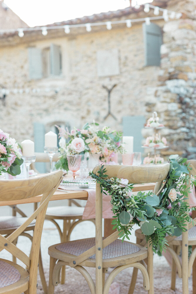 Tablesetting decoration at le clos du tuilier in Provence for a beautiful wedding, saint remy chairs decorated with flowers.