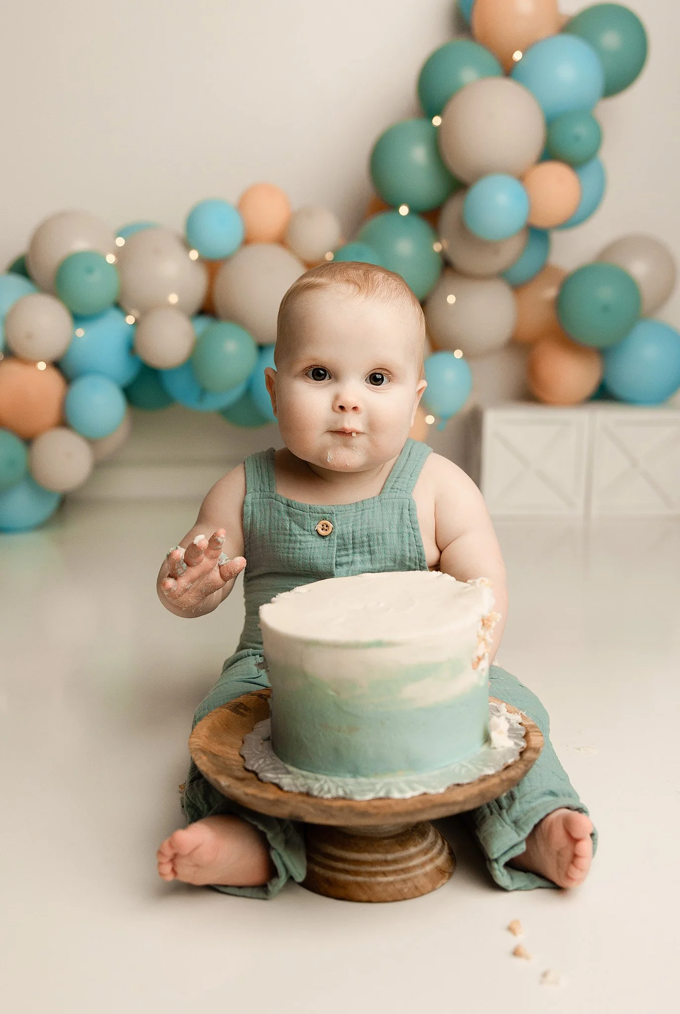 baby exploring cake smash simple styled first birthday session
