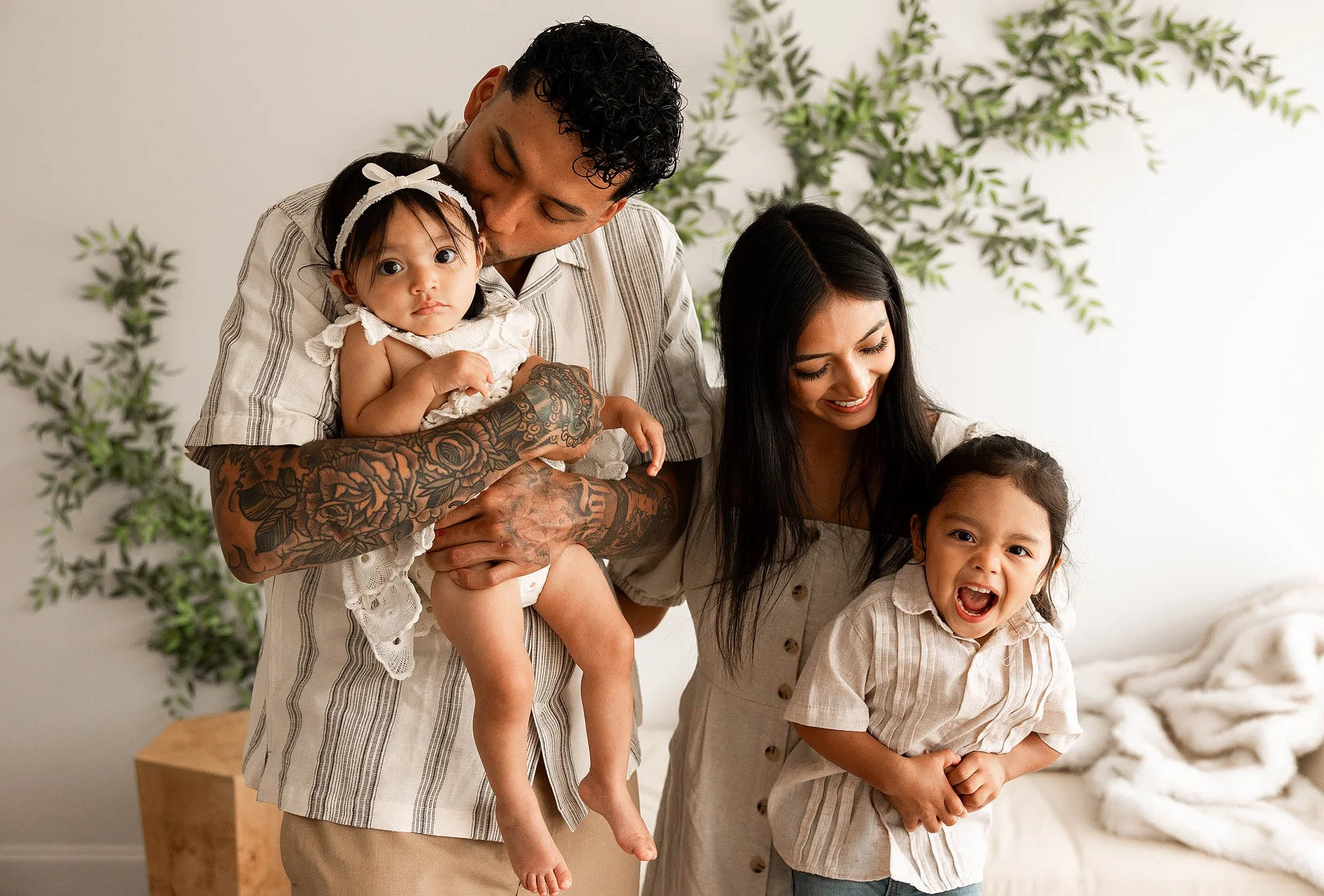 parents holding one year old baby studio photography session