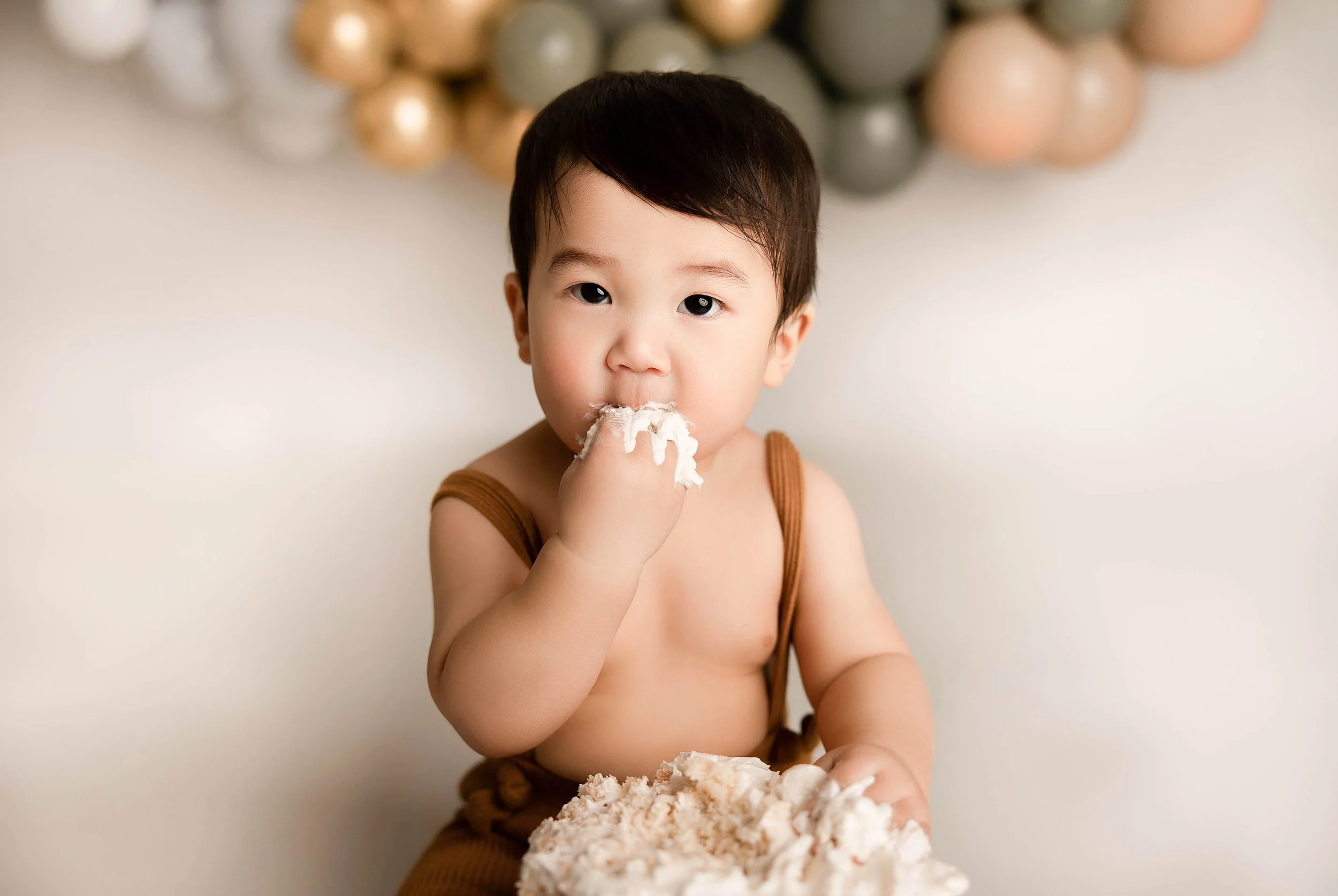 baby exploring cake smash simple styled first birthday session in Detroit