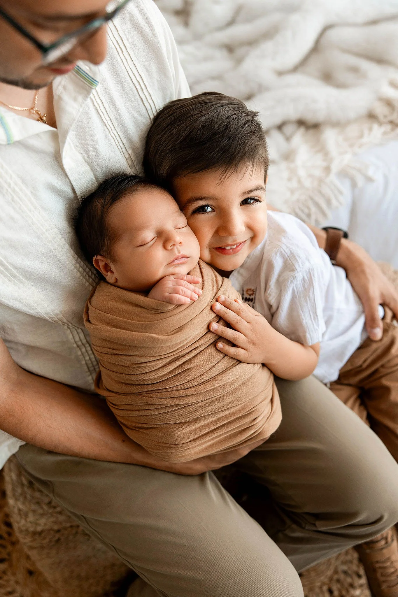 Detroit newborn photographer sibling holding newborn baby
