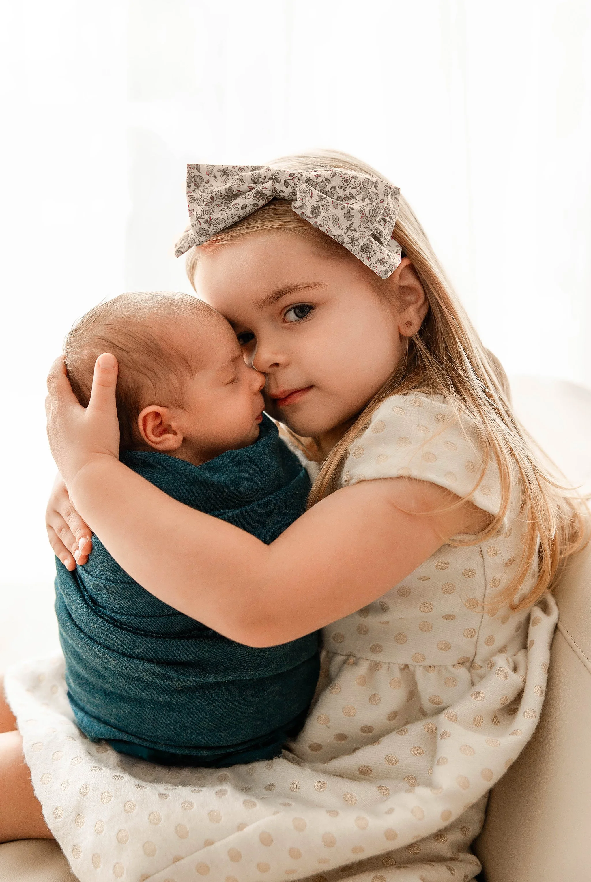 Detroit newborn photographer sibling holding newborn baby
