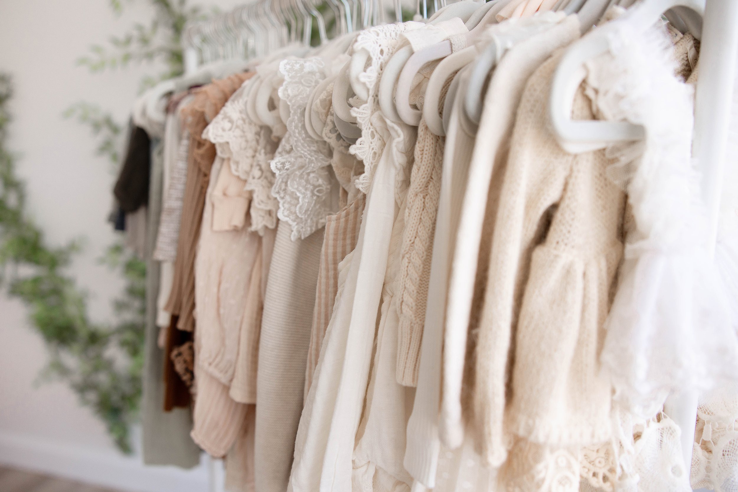 Several baby dresses from the photography Client Closet for baby's to wear during their photoshoots