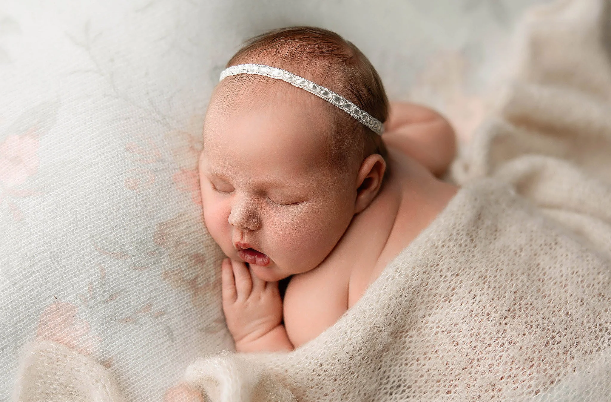 Newborn baby wrapped in soft blanket during Detroit studio session