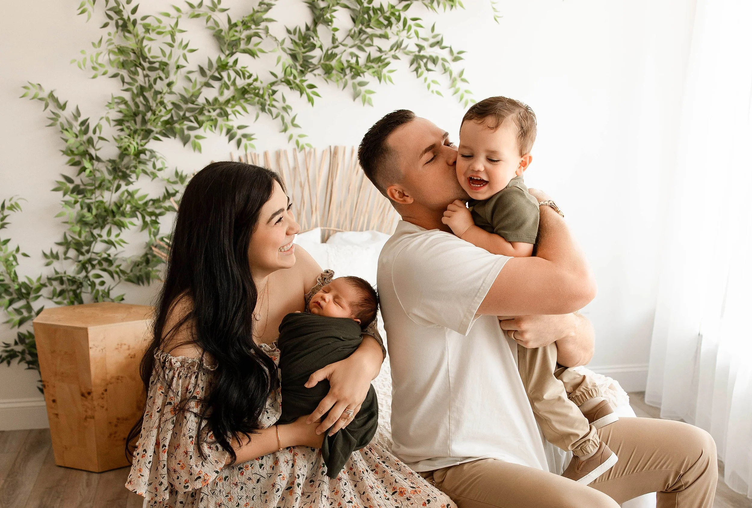 Newborn family photos in a light and airy studio by a Clinton Township newborn photographer