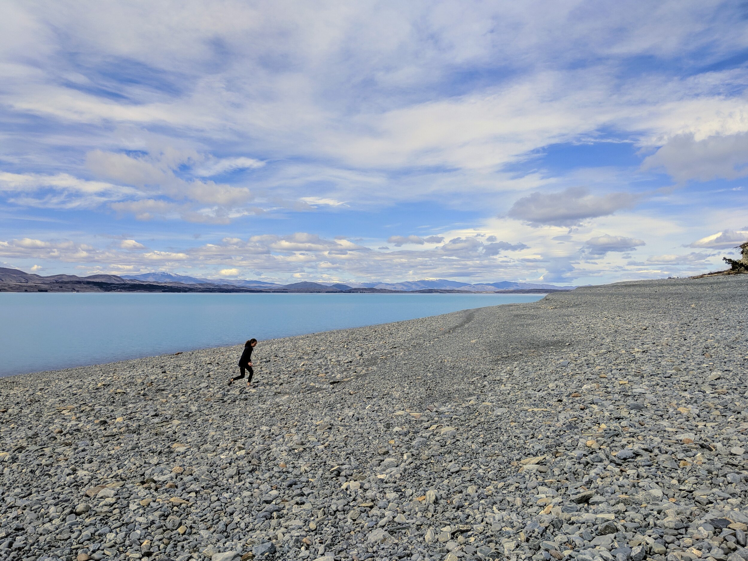  Ada running on the rocky shore of Lake Pukaki. 