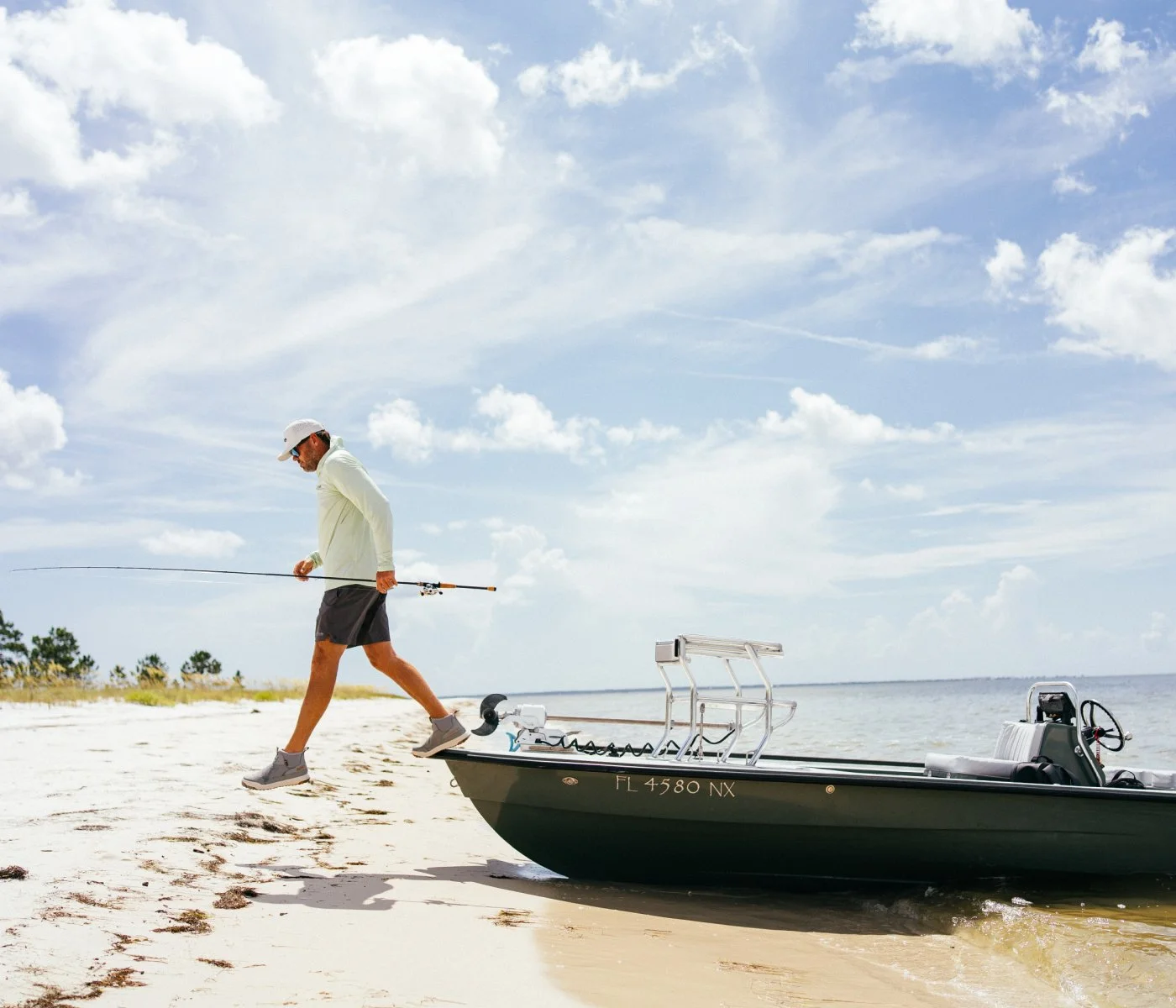 A fisherman hopping off a boat