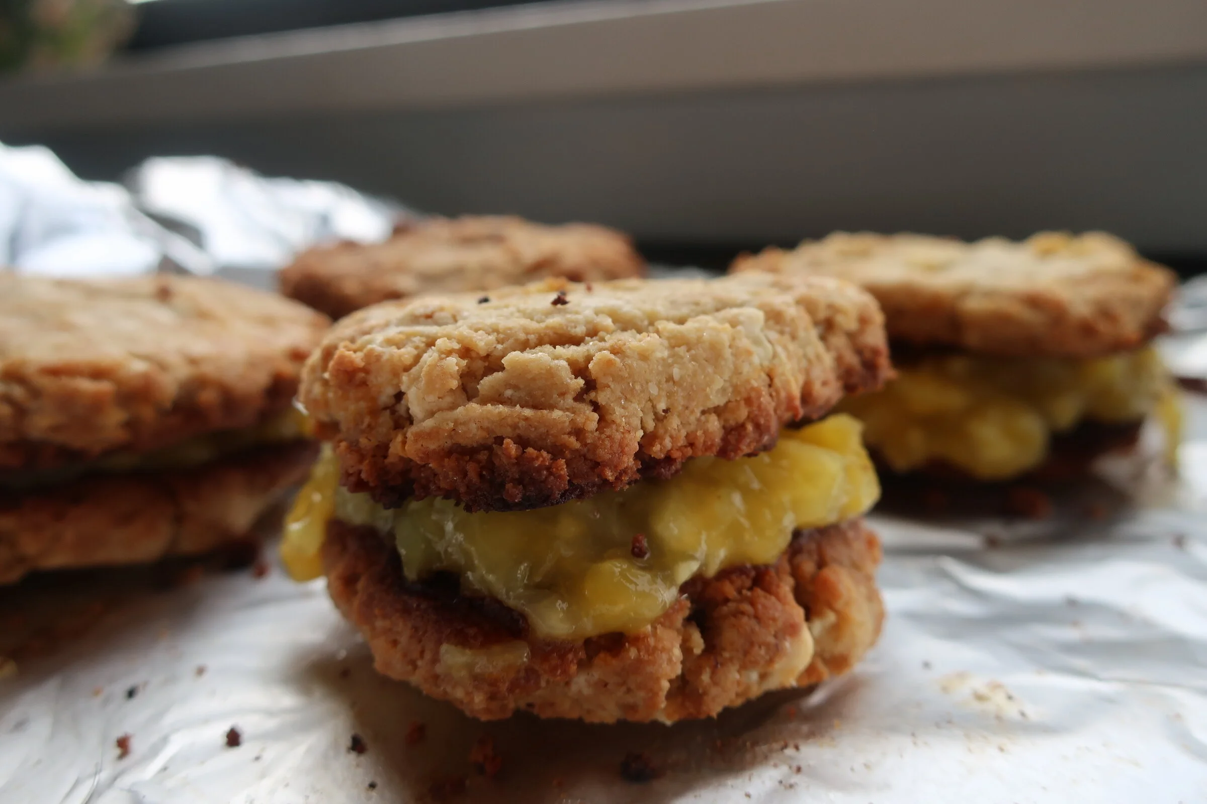 coconut browned butter white chocolate chip cookies with mango pineapple filling