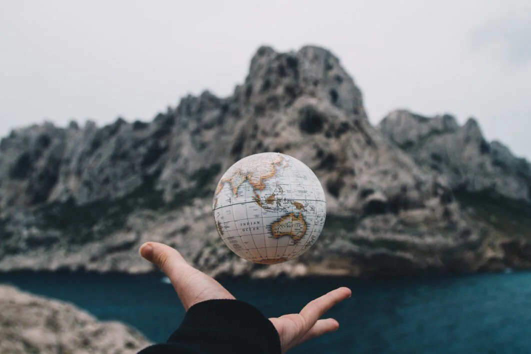 negative-space-man-throwing-globe-world-map-sea-valentin-antonucci-thumb-1.jpg