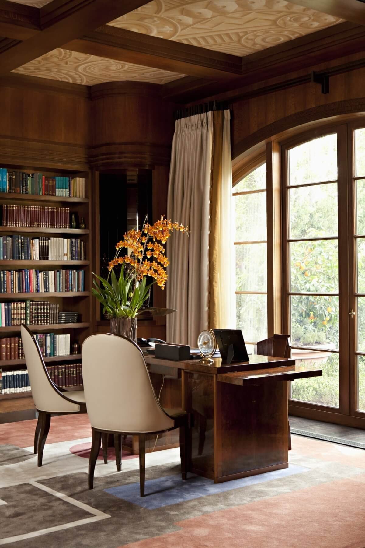 His Office with soffit ceilings, walnut woodwork, custom drapery and an arch window