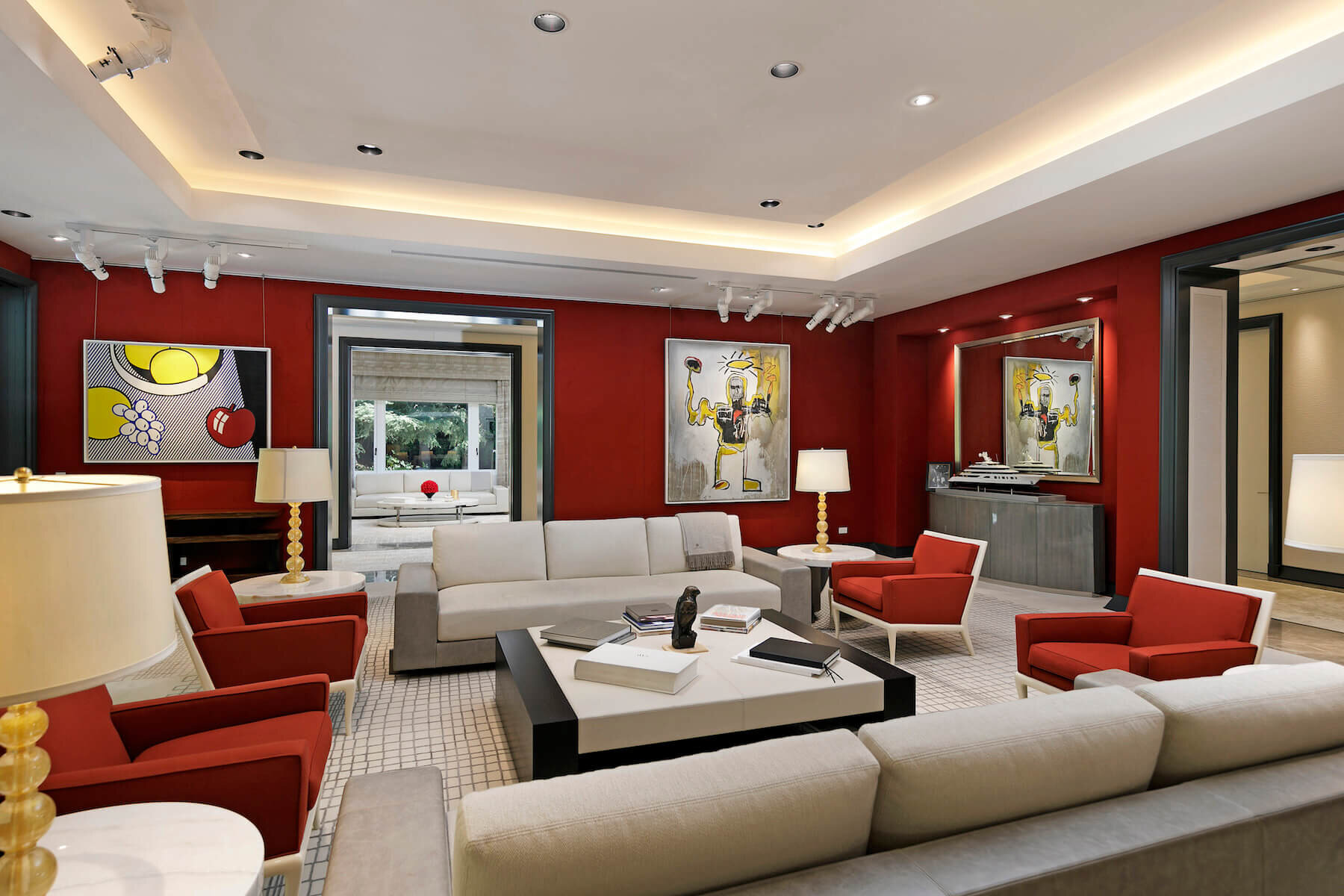 The reception room is outfitted in crimson red wall upholstery  and features a wet bar