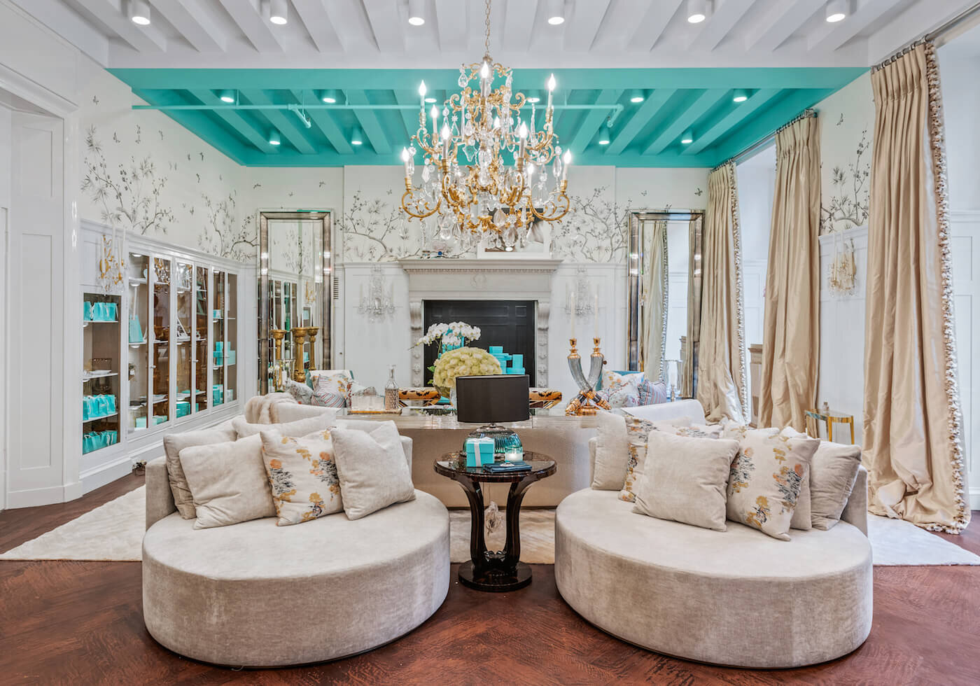 The Holiday House NYC Living room with Tiffany &amp; Co.’s iconic blue on the ceiling, an array of Jimmy Choo accessories , and custom drapery